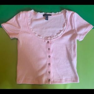 Pink lacey button up shirt.